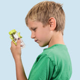Child holding a green and clear container against a white background
